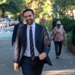 Citadel CEO SLAMS Mayor’s “Tax the Rich” Stunt A man in a suit walking happily in a city park