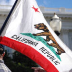 Democrats Self-Destruct: Shocking Debate Fallout California state flag being held up at an outdoor event