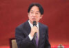 Taiwan Kept in Dark Over $14B Arms Hold Man in suit speaking into a microphone