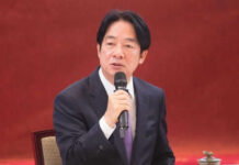 Taiwan Kept in Dark Over $14B Arms Hold Man in suit speaking into a microphone