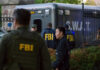 Armed Fugitive Near Stadium — FBI Cash Out FBI and SWAT team gathered near vehicle.