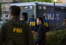 Armed Fugitive Near Stadium — FBI Cash Out FBI and SWAT team gathered near vehicle.