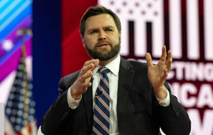 jd-vance2270811629jpg-2 Man in suit speaking on stage with gesturing hands