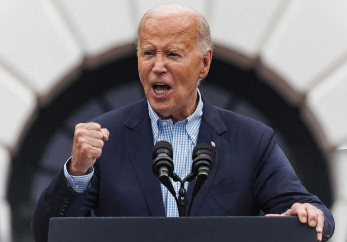 joe-biden-speaks-during-a-4th-of-july2511957023jpg older man speaking passionately at a podium with two microphones
