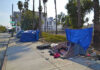 Debt Or Jail: Louisiana’s Wild New Move Tents and tarps line sidewalk near palm trees