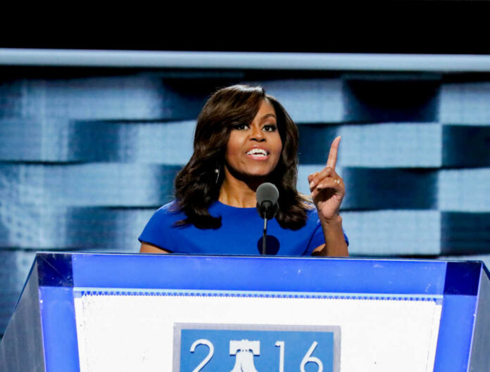 michelle-obama-delivers-her-speech1221256123jpg I dont know who this is speaking at a podium