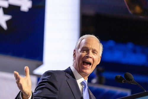 ron-johnson2519822681 Man speaking passionately at a podium on stage