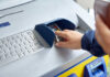 Violent Gang Hits ATMs—Banks Bleed Millions Person using an ATM keypad to perform a transaction
