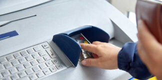 Person using an ATM keypad to perform a transaction