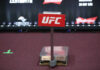 UFC White House Event Hit With Federal Lawsuit UFC weighing scale with promotional signage in the background