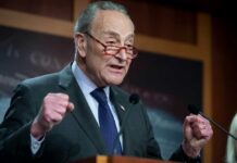 Schumer Goes All-In on Maine’s Controversial Candidate A politician delivering a passionate speech at a podium