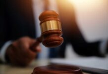 Murder Convict Rakes In Cash, Then Cries Indigent A gavel being struck on a desk in a courtroom setting