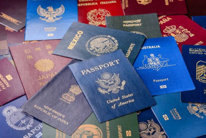 Hands using a calculator with travel documents and notes