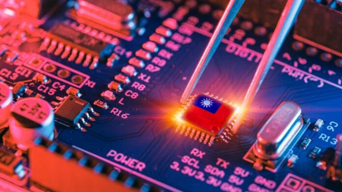 Tweezers placing a microchip on a blue circuit board