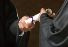 ICE Blitz Triggers Graduation Freak-Out Two individuals exchanging a diploma during a graduation ceremony