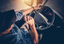 Robot Rigs Coming: Jobs on the Chopping Block A truck driver using a microphone while driving