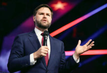 Starmer: Vance Comments Are “Interference” Man in suit speaking with microphone on stage.