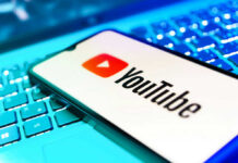YouTube Star Turns Children’s Brand Into Protest Stage YouTube app on smartphone over illuminated laptop keyboard