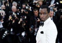 Famous Felon Hits Brick Wall — Trump Unmoved Man in white tuxedo surrounded by photographers.