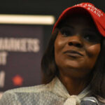 Evidence Avalanche Undercuts Candace Claims Woman in a red baseball cap holding a microphone