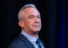 RFK Jr. Shakes Vaccine Payouts I dont know who this is. A man in a suit.