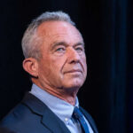 RFK Jr. Shakes Vaccine Payouts I dont know who this is. A man in a suit.