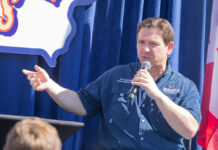 Judge Smacks Down DeSantis Terror Label Person speaking into microphone during public event