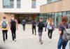 Campus Ideology Rewires Catholic Dorm Life Students with backpacks walking toward a school entrance