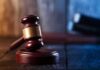 Bodega Owners Sue Over 30% Undercut Judge's gavel resting on wooden block