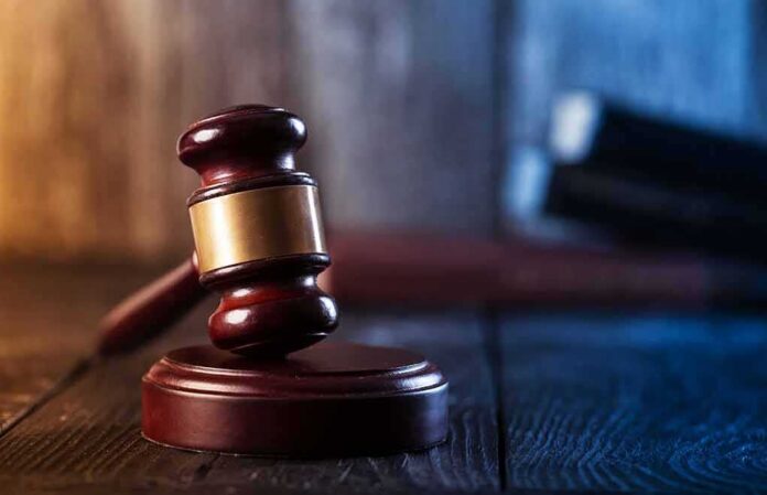 shutterstock_1194443488-1 Judge's gavel resting on wooden block