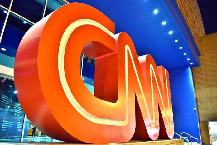 Large red CNN logo sculpture at building entrance