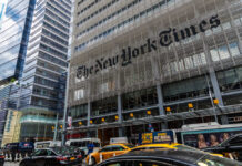 Court Twist Supercharges Trump’s NYT War The New York Times building facade with logo on metal screen