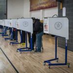 Obama Alum Torched: ‘Wild Speculation’? Voters at polling booths in a gymnasium