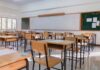 Protest Crackdown? K-12 Shielded, Campuses Spared An empty classroom with wooden desks and a chalkboard