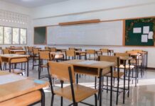 Protest Crackdown? K-12 Shielded, Campuses Spared An empty classroom with wooden desks and a chalkboard