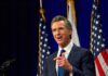 Newsom Targets Ballots, Sparks Constitutional Fight California governor speaking at a construction site with smiling attendees