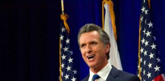 California governor speaking at a construction site with smiling attendees