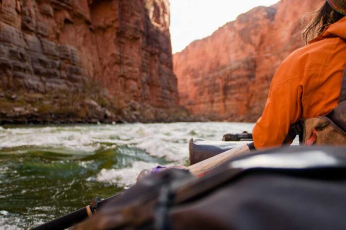 Rafting,Down,The,Colorado,River,In,Grand,Canyon Hiker overlooking expansive canyon landscape