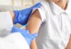 Herd Immunity Shattered In England A healthcare professional administering a vaccine to a child's arm