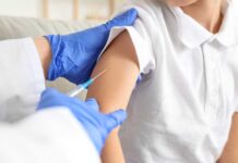 Herd Immunity Shattered In England A healthcare professional administering a vaccine to a child's arm
