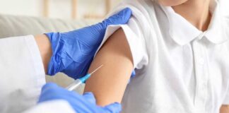 A healthcare professional administering a vaccine to a child's arm