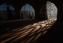 Hollywood Comedian Torches ‘Islamophobia’ Push Interior view showcasing intricate geometric patterns and shadows cast by windows
