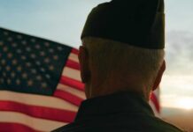 Steak ’n Shake Hands Veterans The Keys A veteran in uniform standing in front of an American flag at sunset