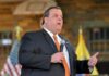 Monumental Defeat—or Manufactured Drama? A man in a suit speaking into a microphone at an event