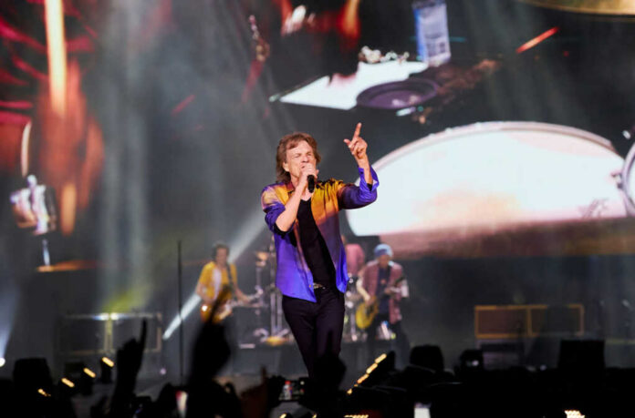 Lead singer performing on stage at a large concert
