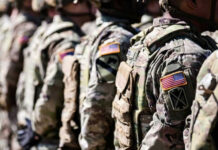 Alleged Assaults Vanish From Dahmer File Soldiers in camouflage with American flag patches standing