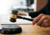 Private Money, Public Battle: Ballroom on Ice Judge's hand holding a gavel over a sound block