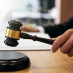 Private Money, Public Battle: Ballroom on Ice Judge's hand holding a gavel over a sound block