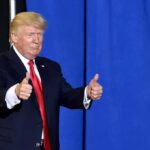 Trumpapalooza Ignites Dallas — What’s The Play? man in suit giving two thumbs up