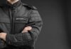 Security Orders Cover-Up — League Backtracks security guard in black uniform with crossed arms